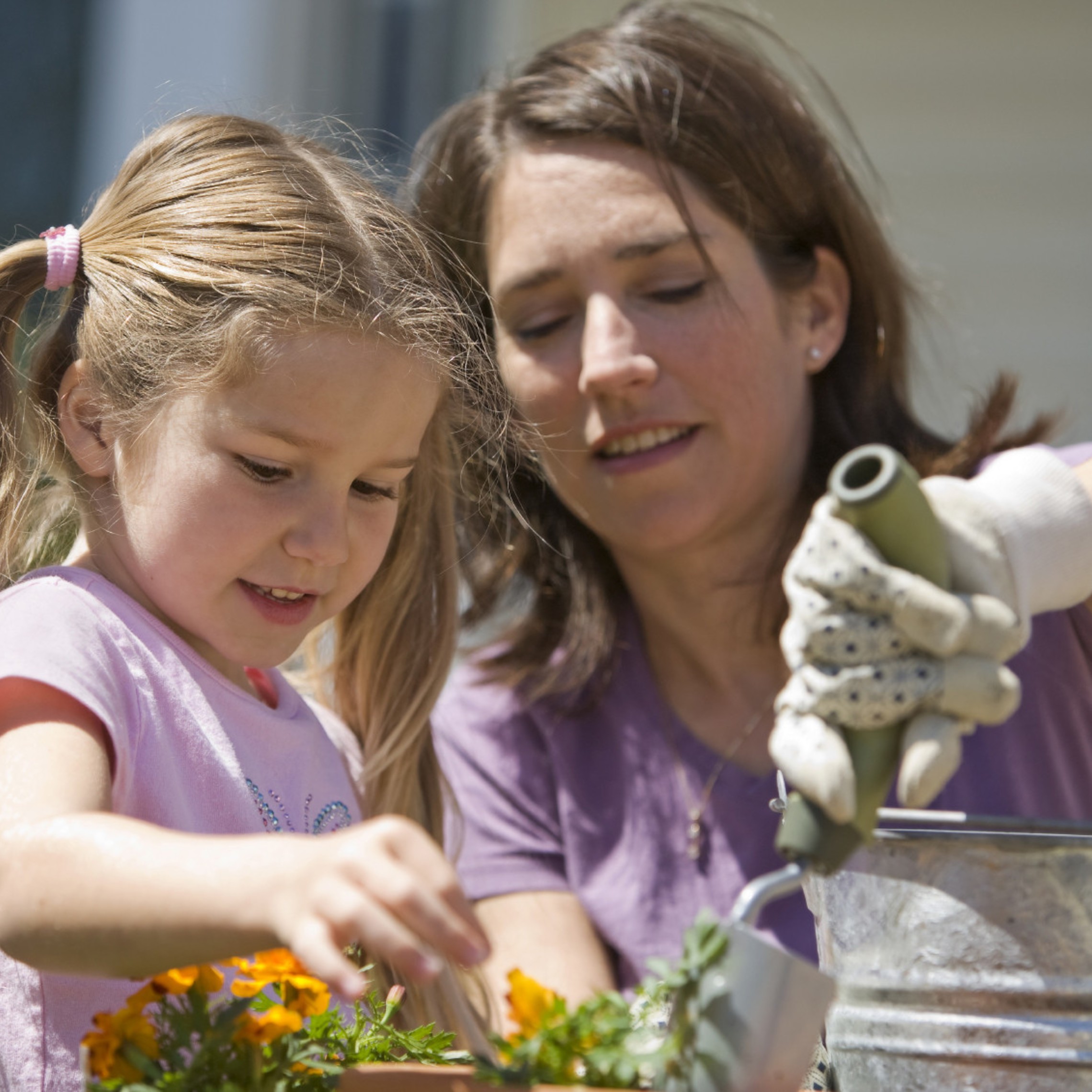 Mother And Girl Planting
